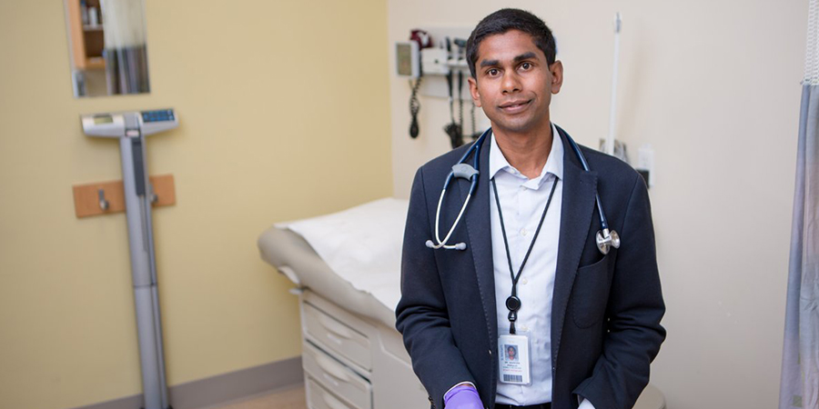 Dr. Nav Persaud standing in a patient room
